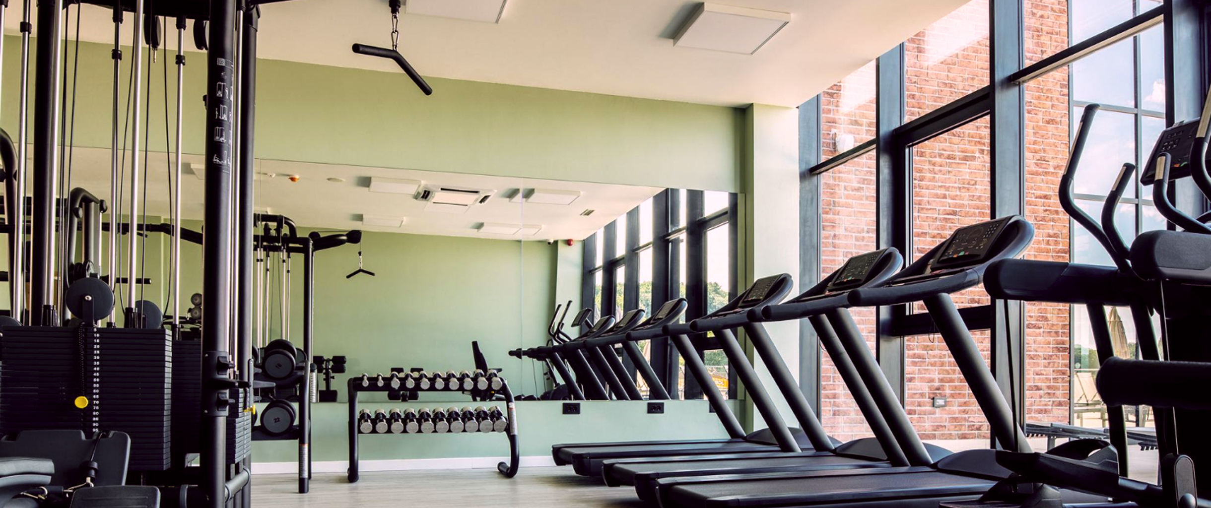 на изображении спортивный зал с беговыми дорожками и другими тренажерами
